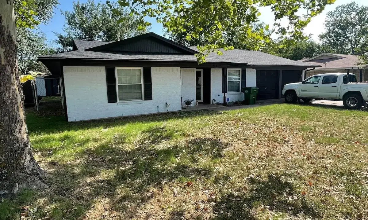 Professional roofing crew working on a residential roof in Connersville